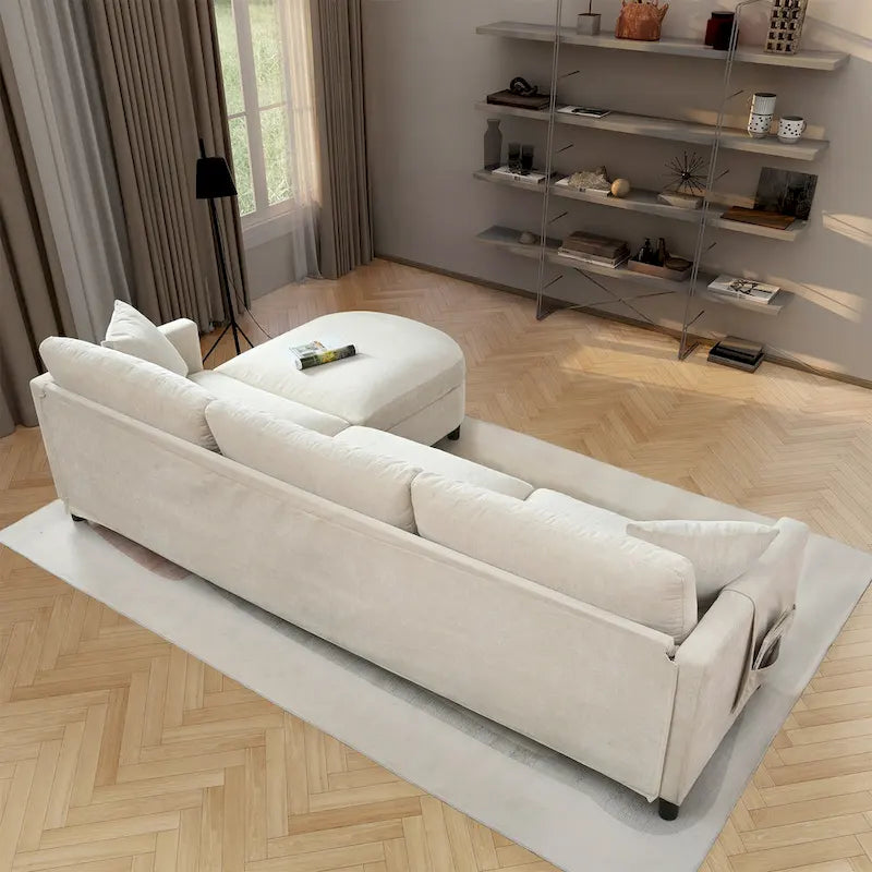 Canapé d'angle en tissu beige avec pouf rond mobile et accoudoir-sac